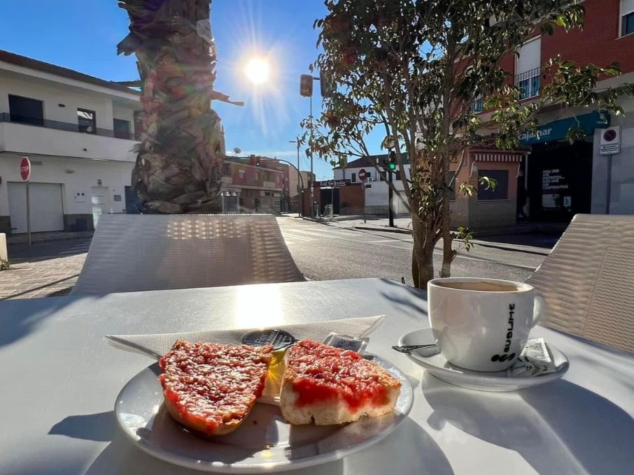 Typical Spanish breakfast of tomato on toast with olive oil and coffee in Sucina